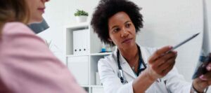 doctor showing the patient her Patient Forms
