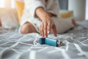 women reaching for her Asthma Management
