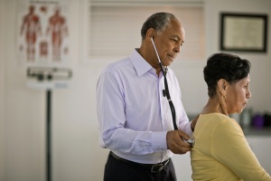 doctor doing a health screening on patient