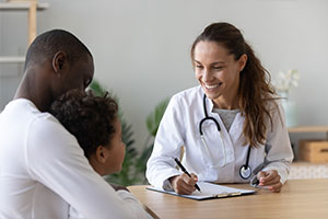 doctor talking with parent and child about asthma