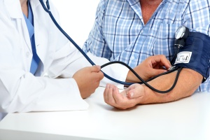 older man having a doctor checking a mans Blood Pressure Management