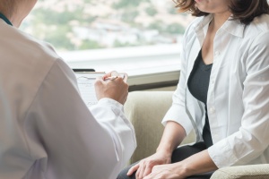 Women talking to patient in her office