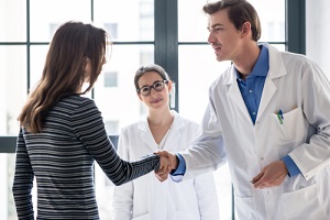 dedicated reliable Primary Care Provider  and female patient shaking hands