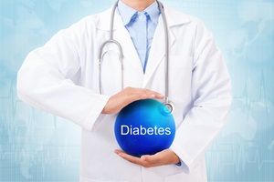 doctor holding blue crystal ball with warning signs of diabetesn on medical background