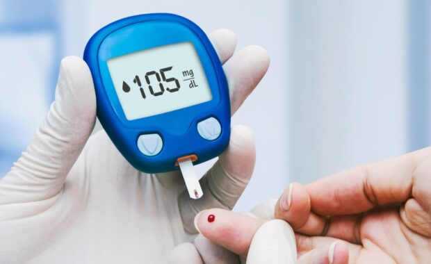 doctor making blood sugar test in clinic for diabetes