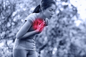 A woman who is suffering from asthma feeling uneasy after doing extensive workout