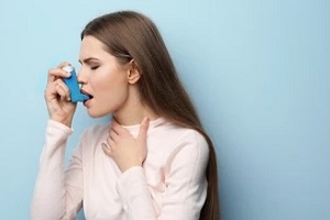 girl taking asthma inhaler after knowing how do you get diagnosed with asthma