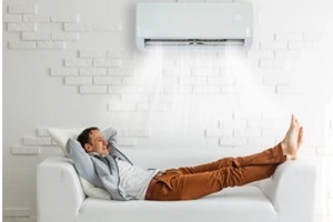man lying under ac and relaxing