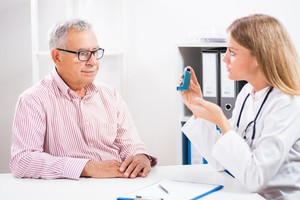 An old man consulting a doctor for asthma