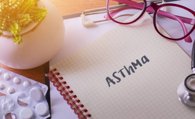 Asthma written on paper and medicines beside it