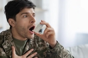 man taking inhaler after asthma attack