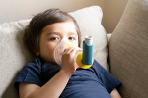 A boy using inhaler for breathing