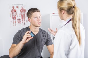 A man asking questions about asthma management to a female doctor