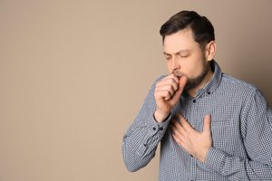 A man coughing