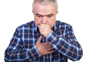 A man showing asthma symptoms of difficulty in breathing