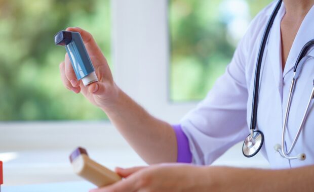 Doctor showing inhaler for better asthma management