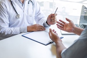 Man consulting doctor about general health