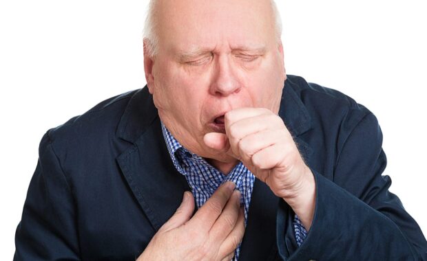 An old man experiencing a mild asthma attack