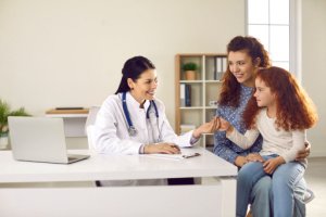 Gynecologist checkup of an early teenage girl with her mother