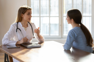 A gynecologist and her patient during the wellness visit