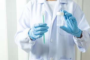 A gynecologist is checking a pap smear test sample