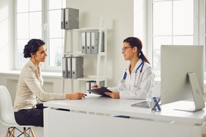 A young woman with a doctor for a women's wellness exam