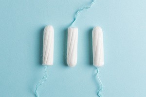 Three tampons on blue background