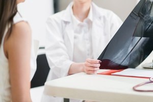 A doctor showing a mammogram to her patient