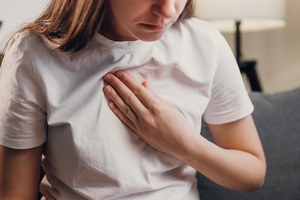 A woman experiencing pain in her chest
