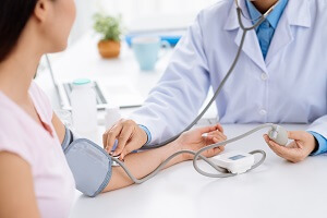 doctor checking blood pressure