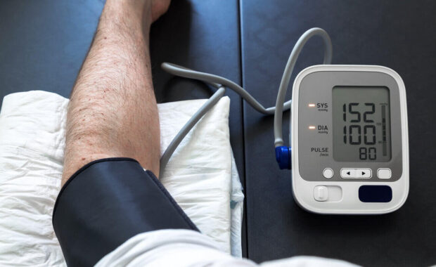 hypertensive patient performing a blood pressure auto test