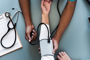 nurse measuring patient blood pressure