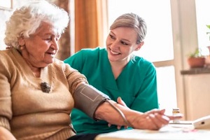 old lady with doctor checking blood pressure