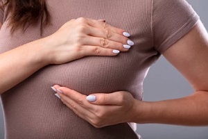 women hands performing self breast examination