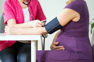 checking blood pressure of pregnant women