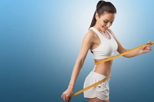 fit woman measuring waist