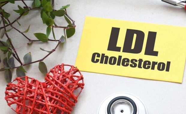 word ldl cholesterol on a small piece of paper next to a stethoscope