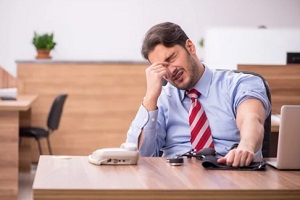 stressed man while checking blood pressure