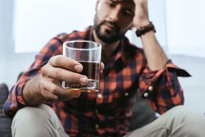 stressed man while drinking alcohol