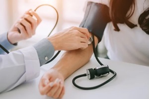  Durham, NC doctor checking blood pressure of women