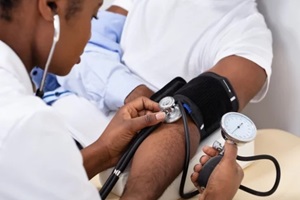 Durham, NC primary care doctor measuring blood pressure of patient