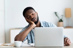 exhausted african american worker felt asleep at workplace