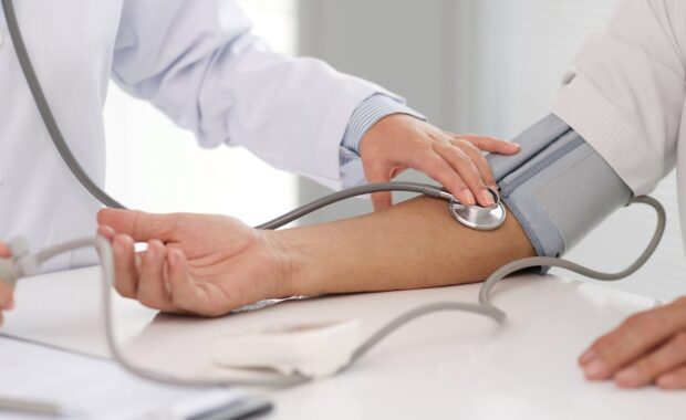 doctor checking blood pressure
