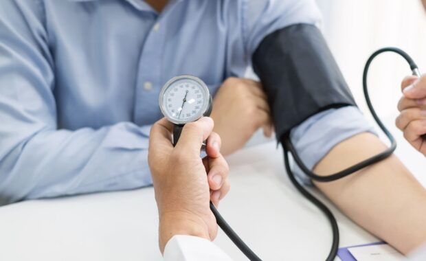 family doctor is checking the blood pressure of the patient in Durham, NC