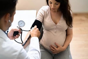 NC primary doctor checking pregnant lady blood pressure