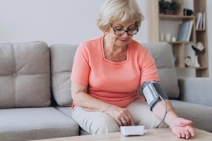 aged women measuring blood pressure at home