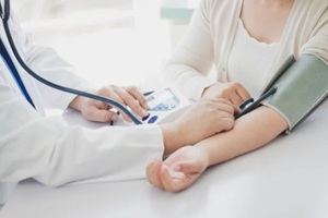 measuring the blood pressure of a patient