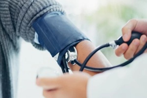 NC primary care provider measuring the blood pressure of a patient