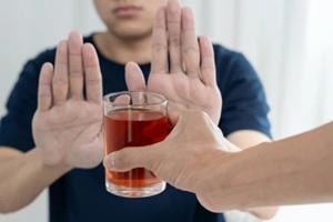 man refuses say no and avoid to drink an alcohol whiskey