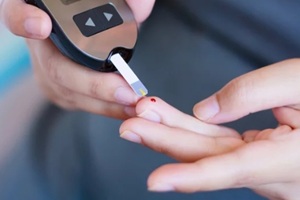 checking blood glucose with glucometer